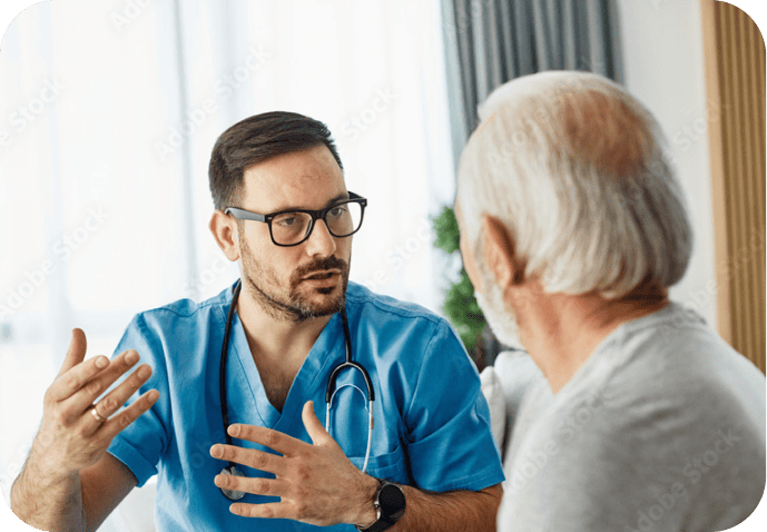 A male doctor speaking to his elderly male patient.