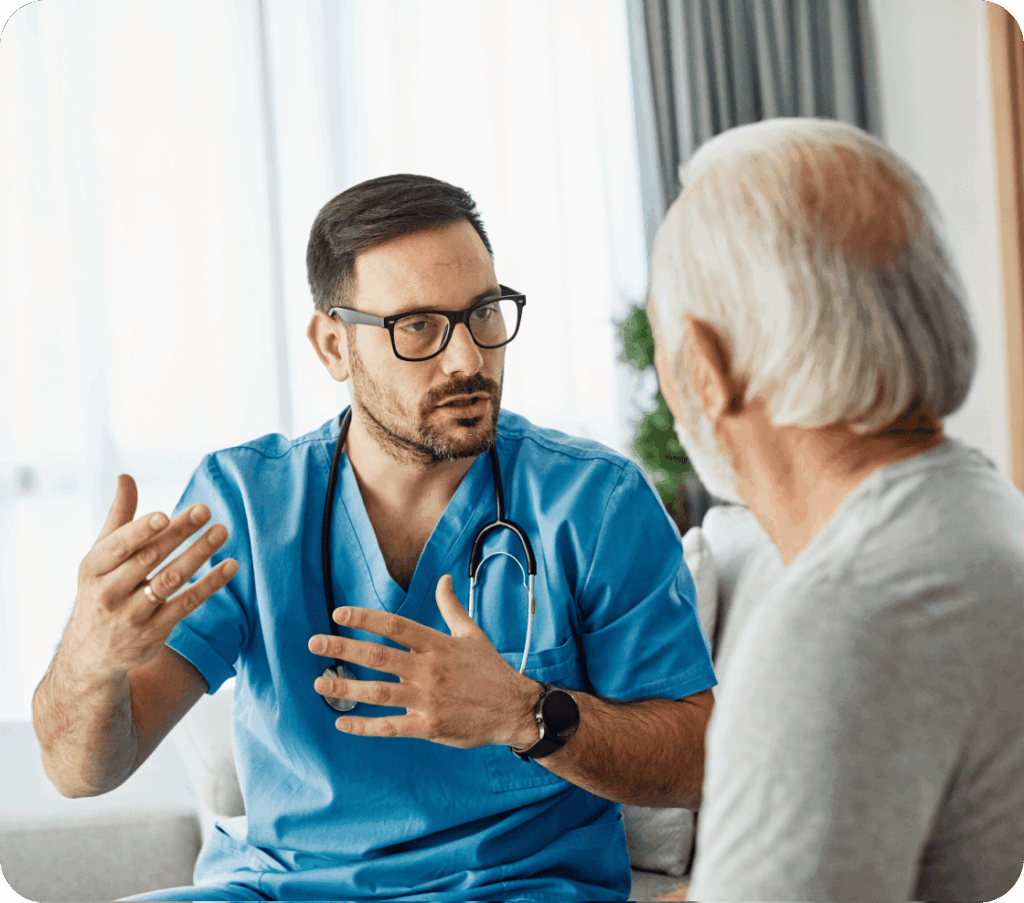 A male doctor speaking to his elderly male patient.